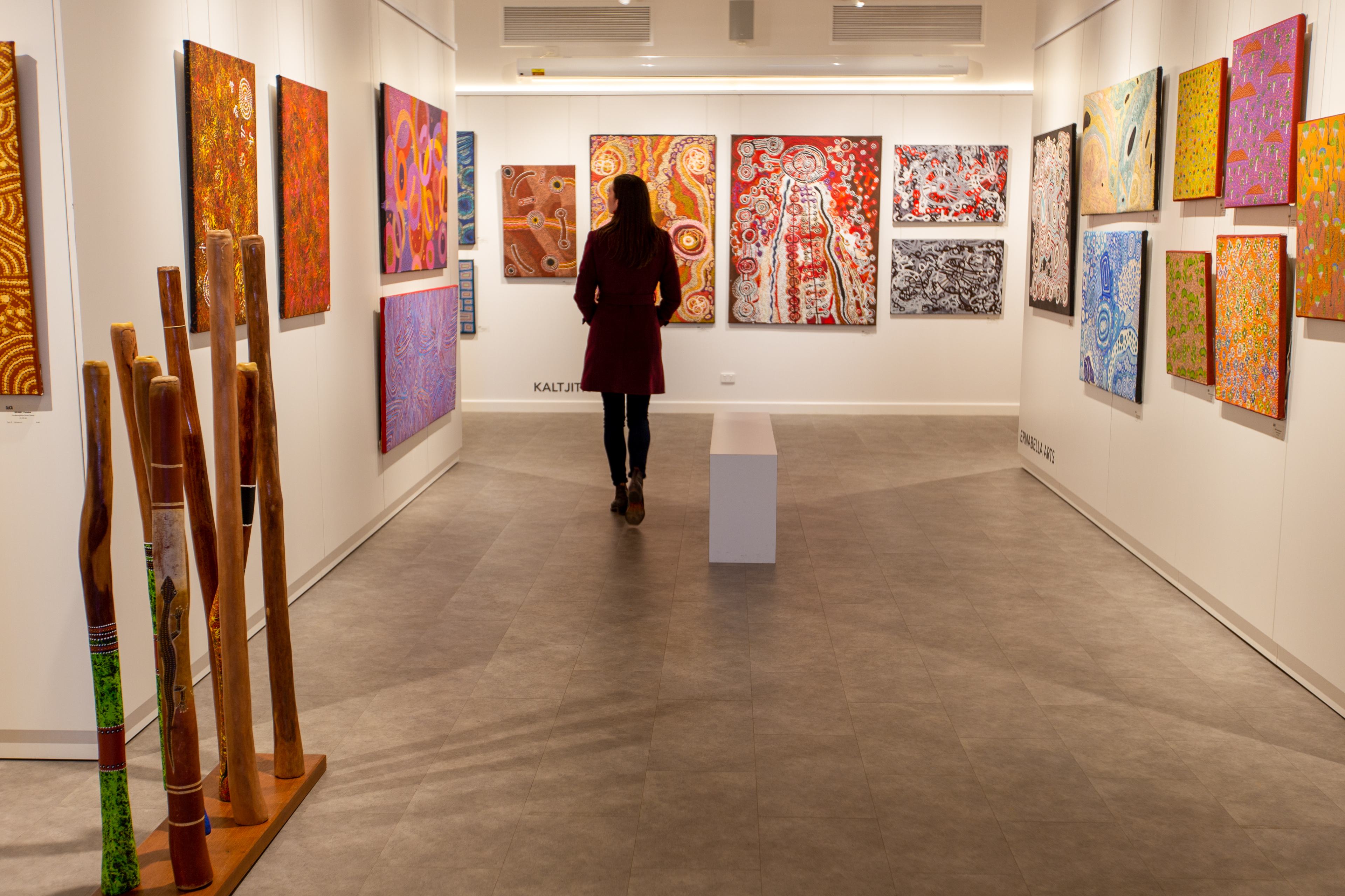 Woman browsing artwork in an art gallery at Ayers Rock Resort