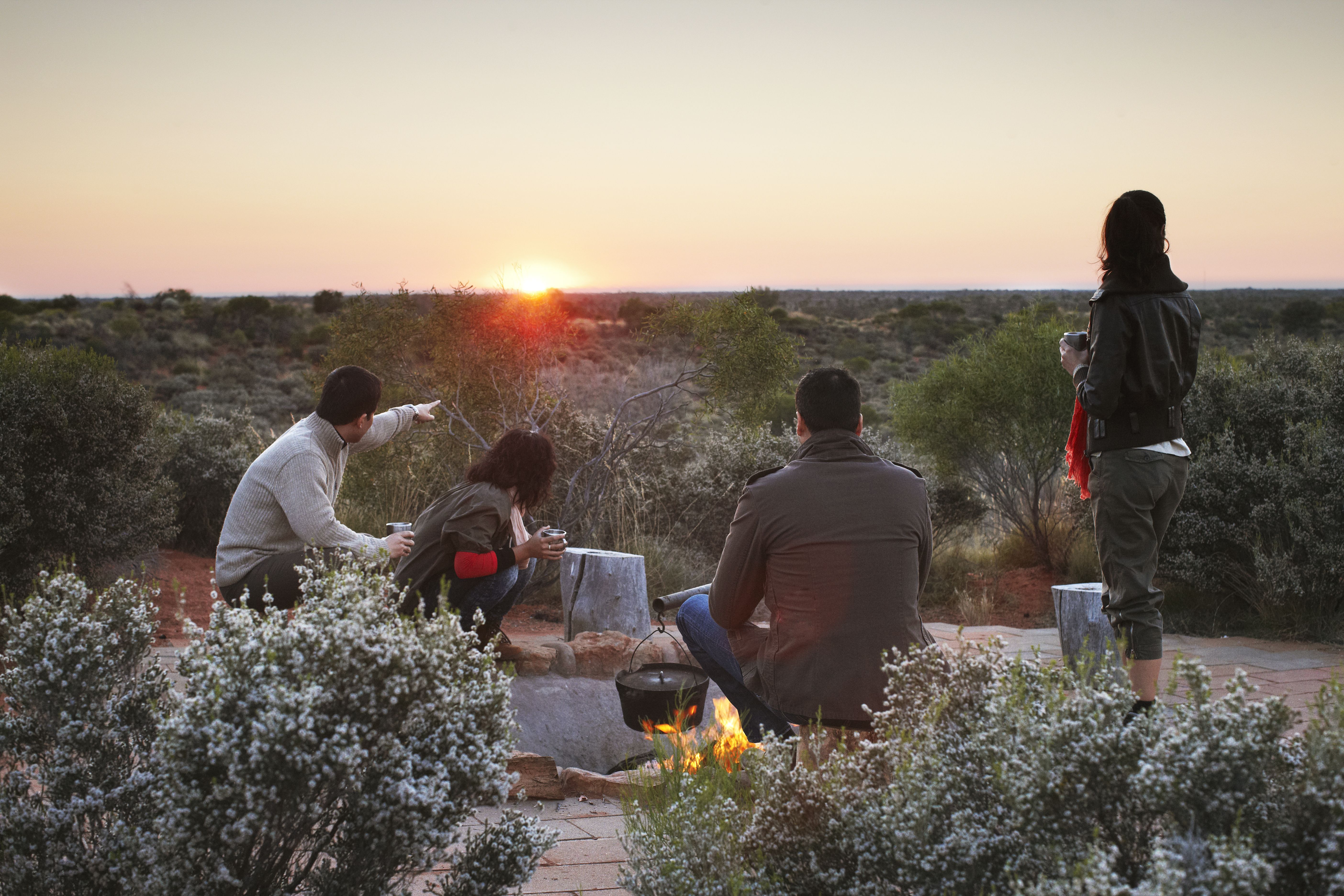 desert awakenings group pointing at sunrise