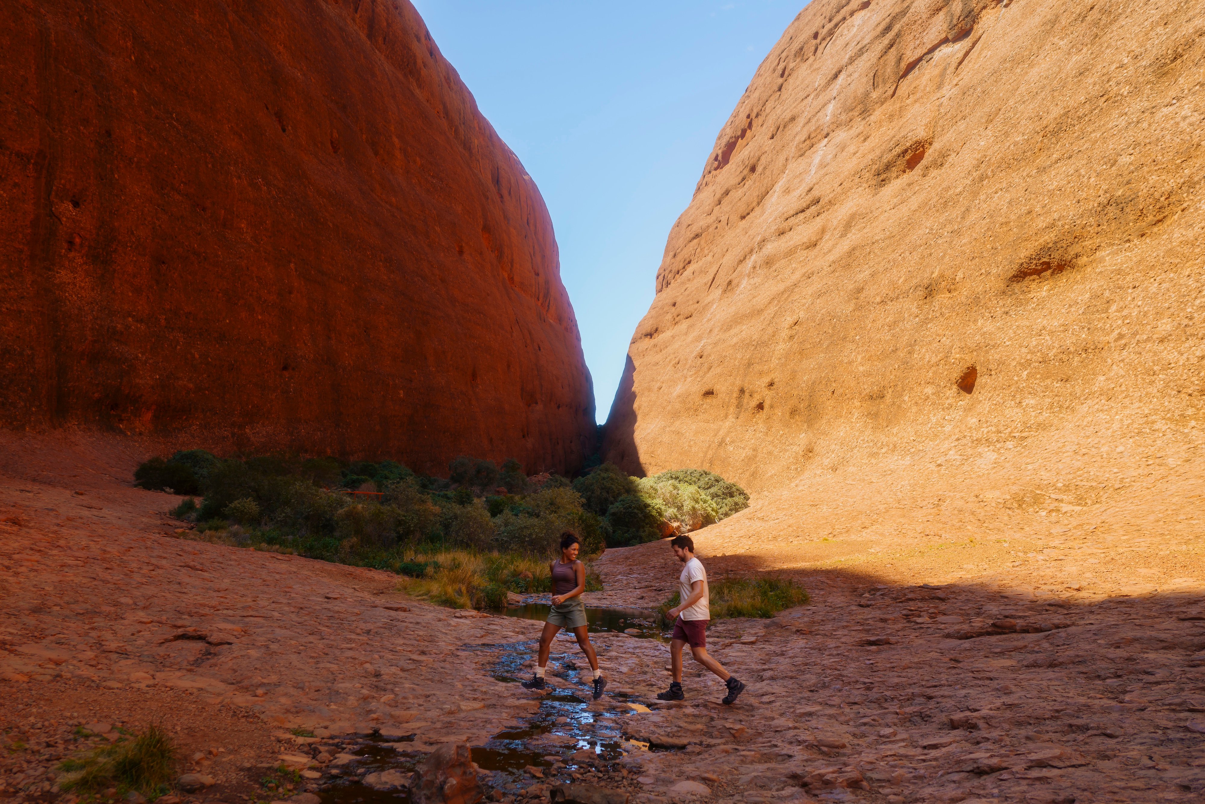 A couple hiking through a large gorge