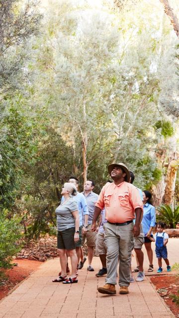 Group taking guided tour of gardens at Ayers Rock Resort